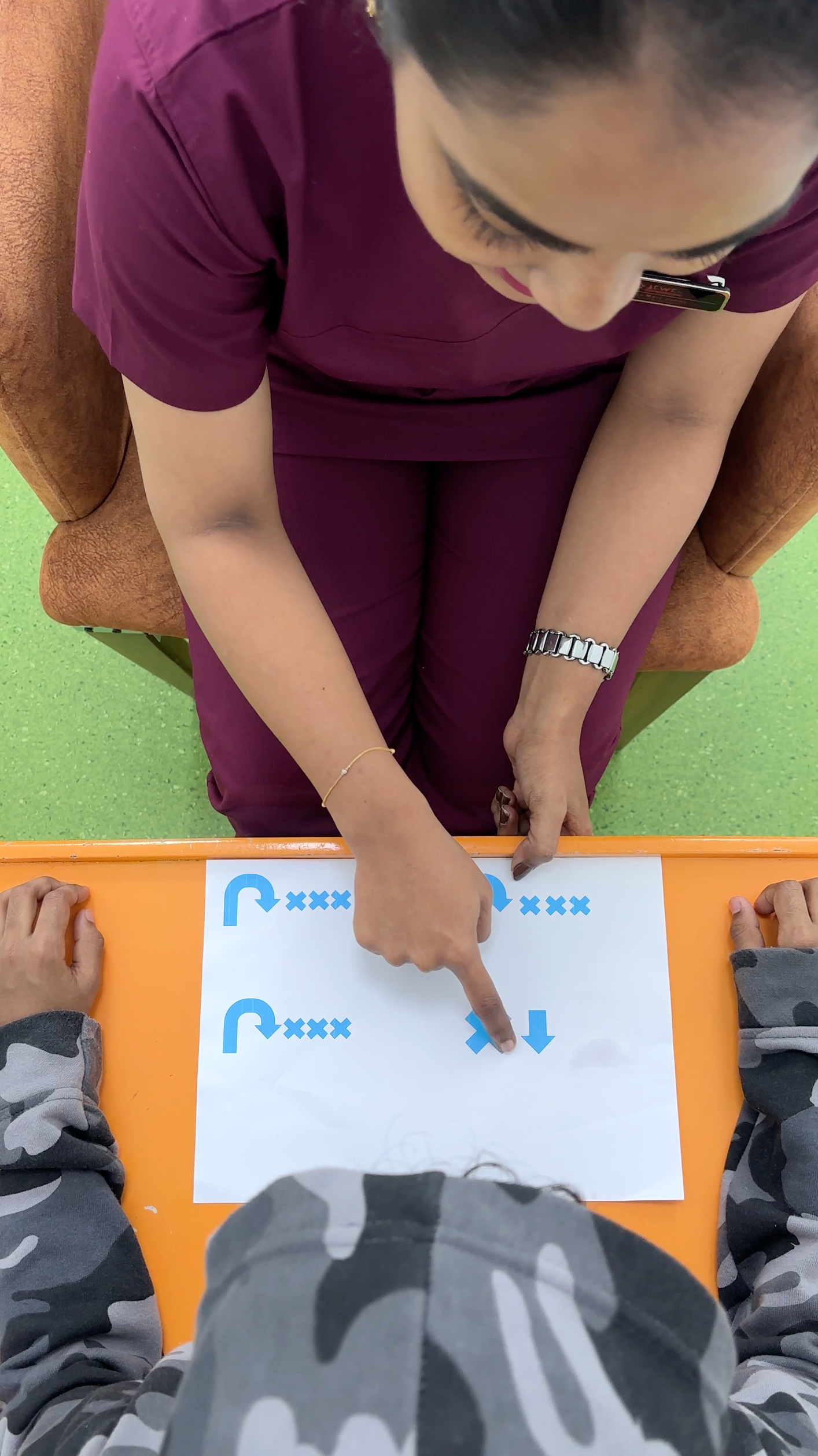 Therapist at the best speech therapy center in Dubai guiding a child through a visual direction-following activity.